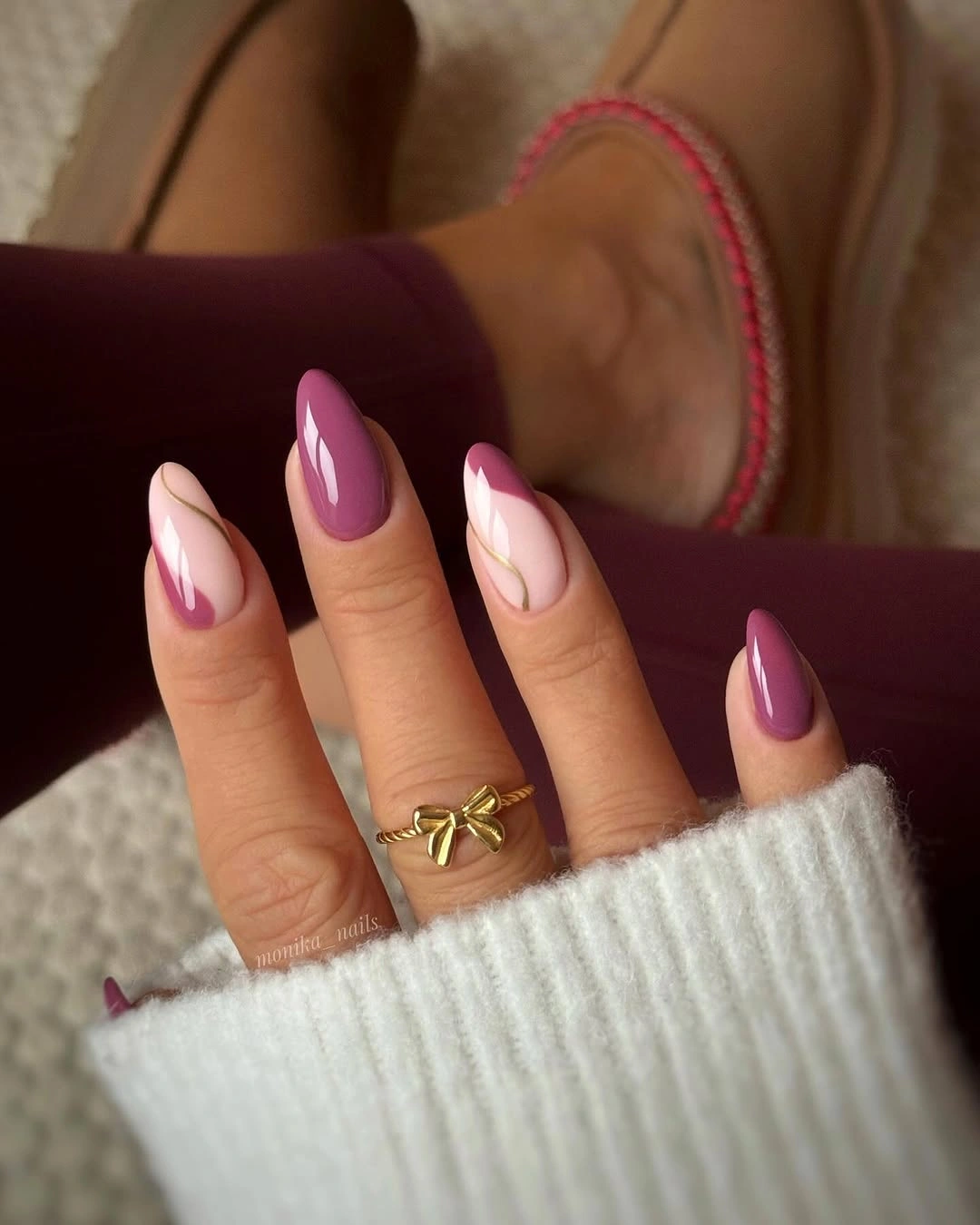Glossy plum almond nails with pale curved edges