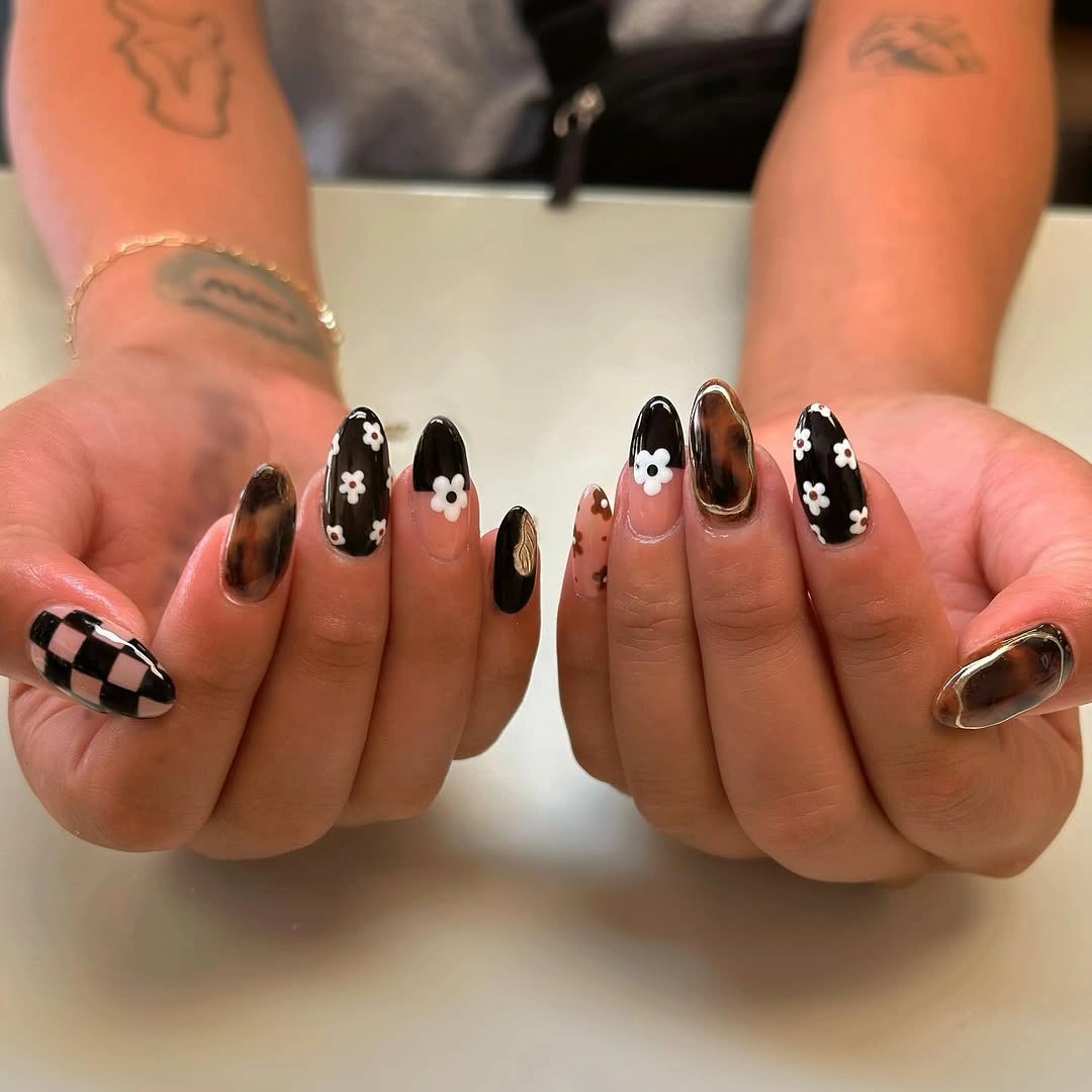 Medium almond nails with flowers dots and checkerboard detail
