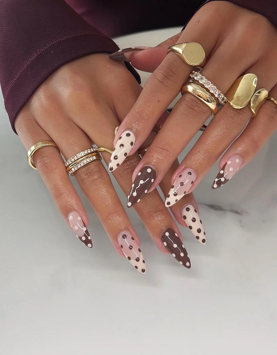 Long pointed nails with spotted brown and pale tips