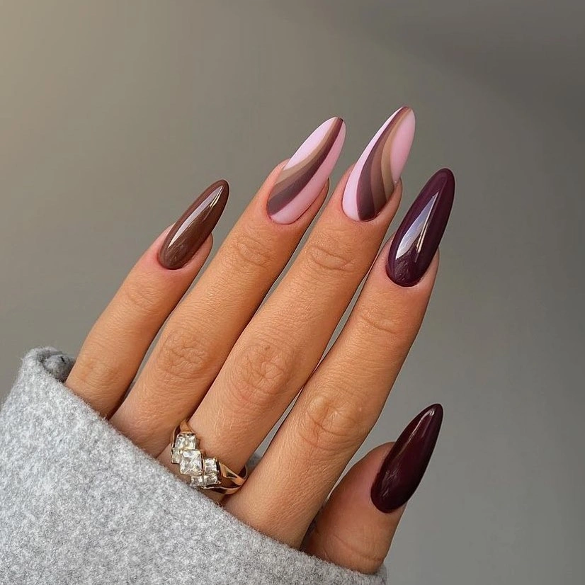 Long almond nails in plum mauve and warm brown shades