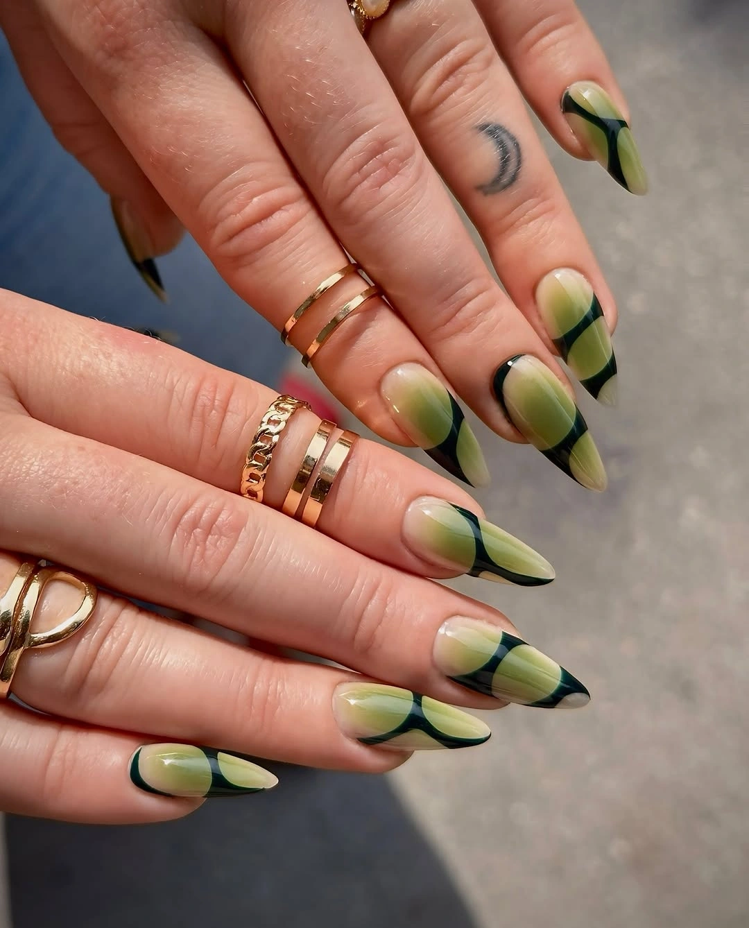 Long almond nails with green yellow and black curved bands