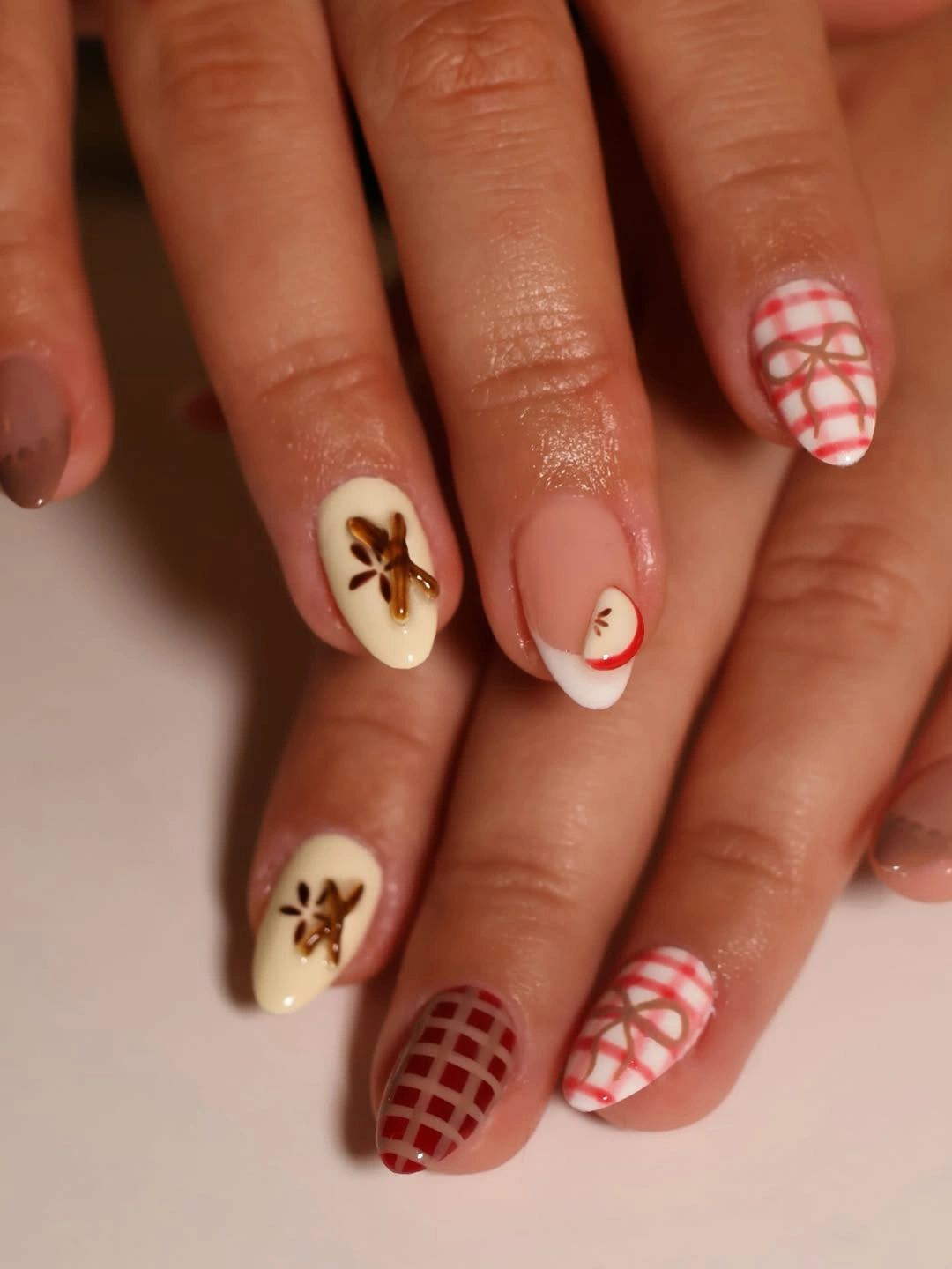 milky cream manicure with brown checker details