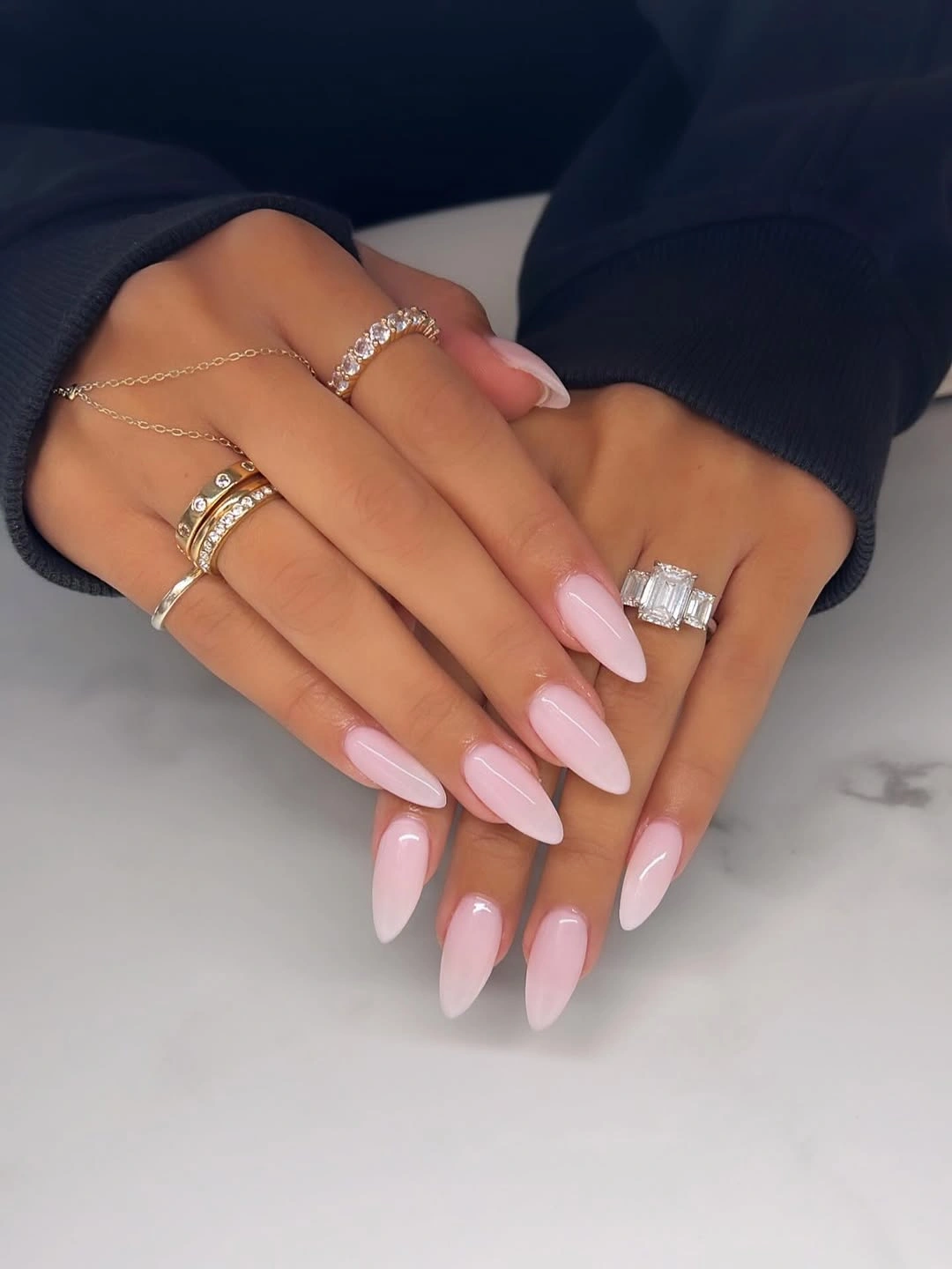 glossy burgundy almond nails with jewel-like accents