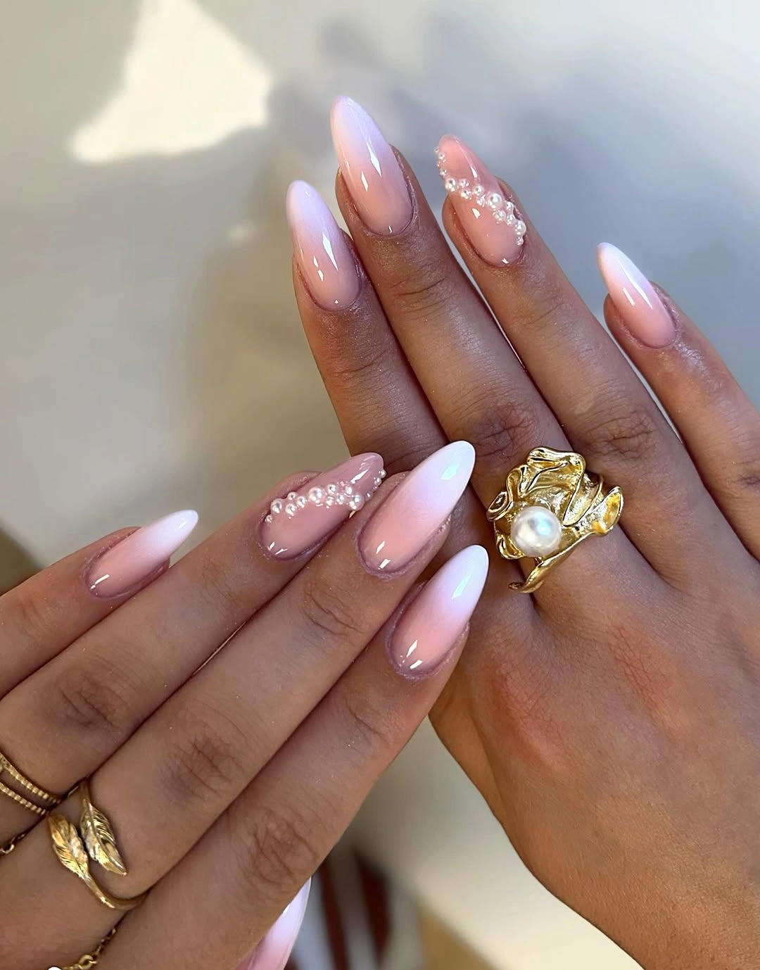 sheer pink nails with warm orange and olive accents
