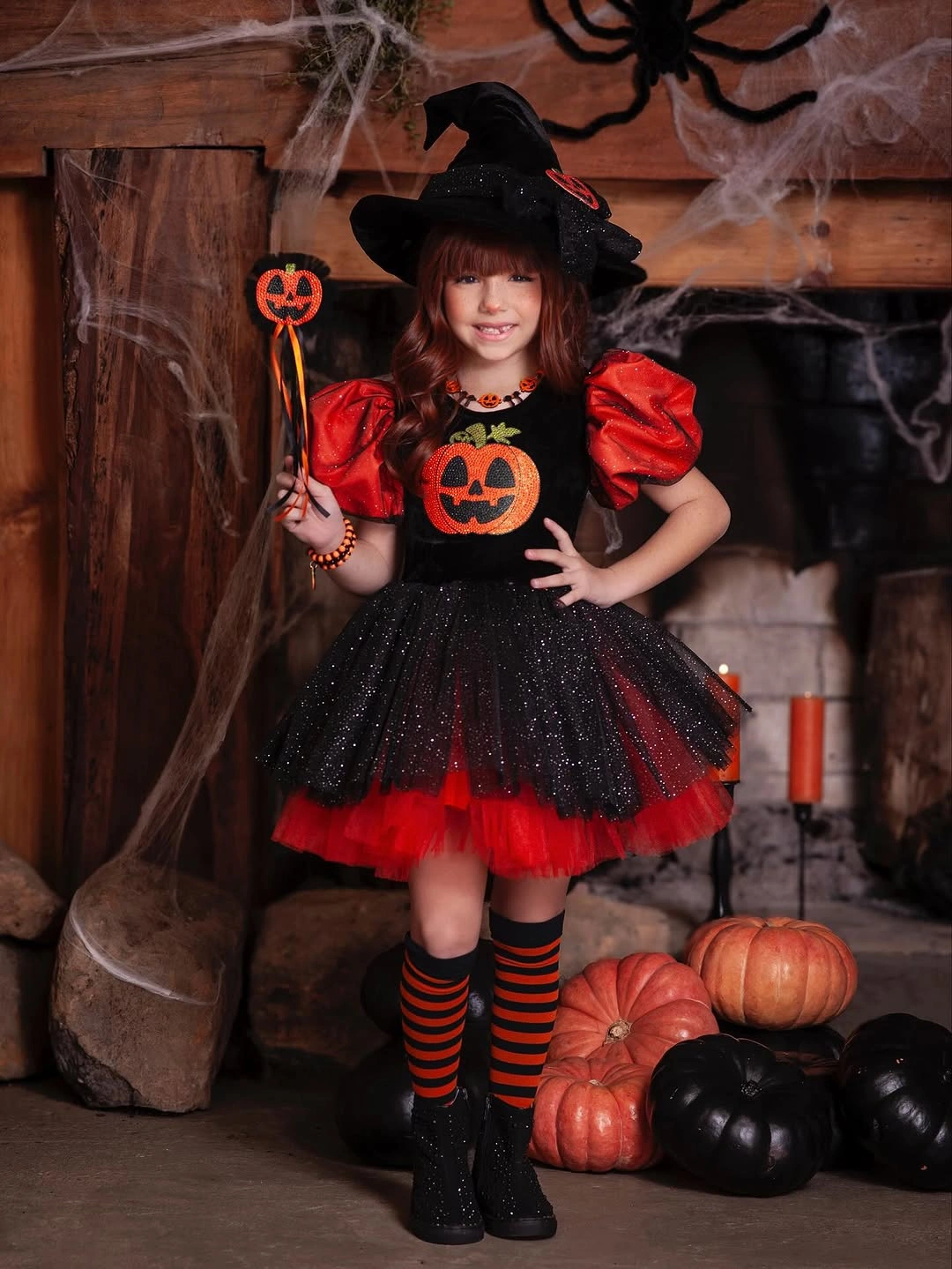 black outfit with short dark dress with puff sleeves, flared skirt, and pointed hat