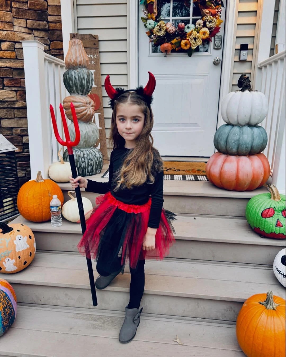 black outfit with fitted dark dress with red layered skirt and horn headband
