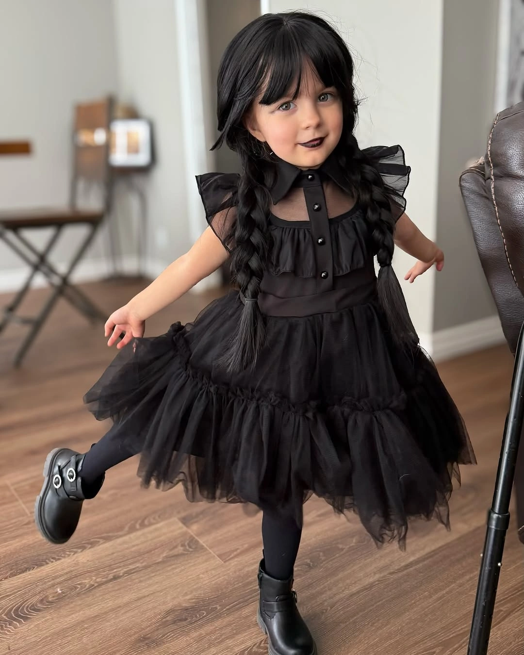 black outfit with buttoned fitted bodice with tiered skirt and short sleeves