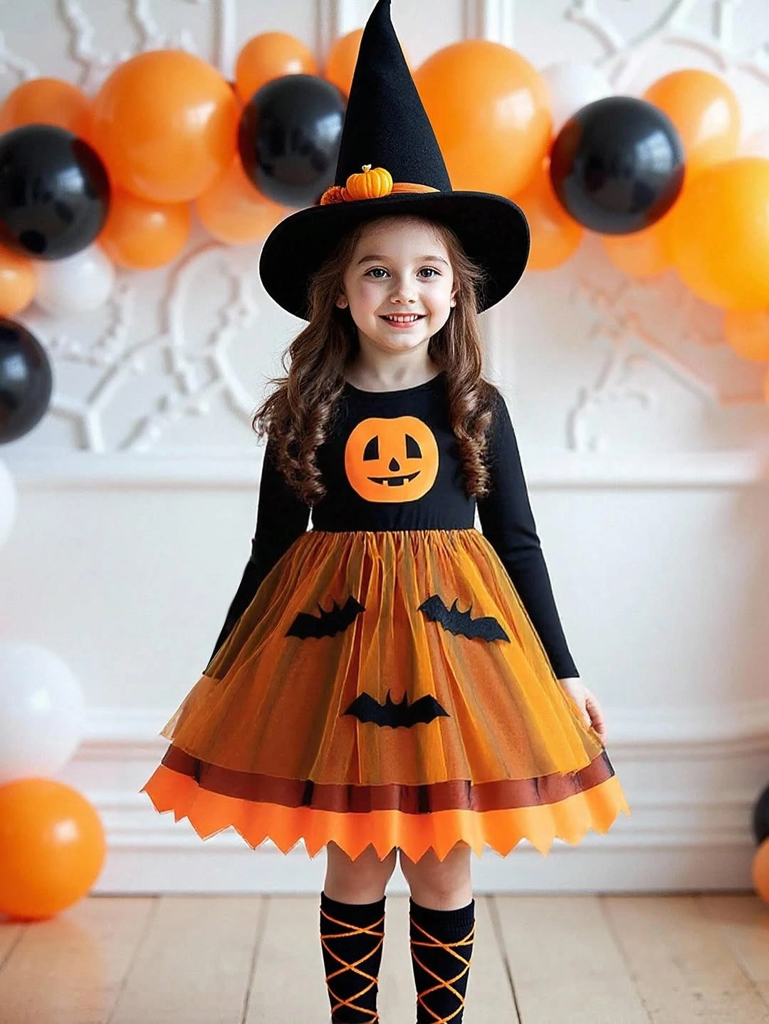 orange outfit with fitted black top under flared pleated skirt with tall hat
