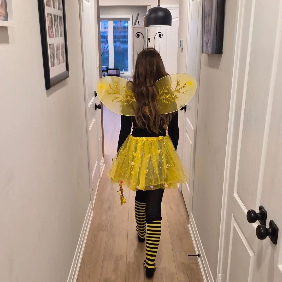 yellow outfit with broad wings over short tulle skirt with striped legs