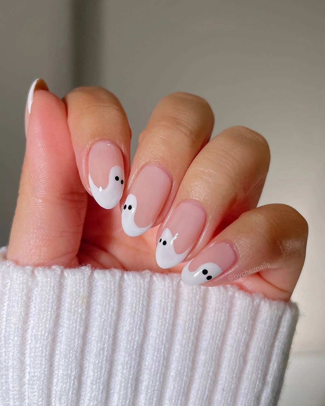 Medium almond pale nails with simple white ghost faces
