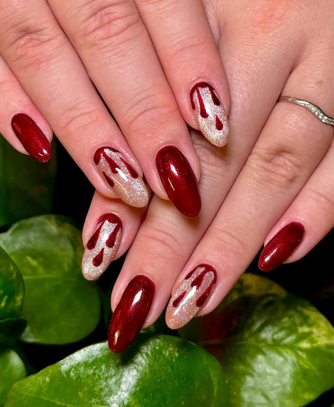 Medium almond glossy red nails with pale dripping accents