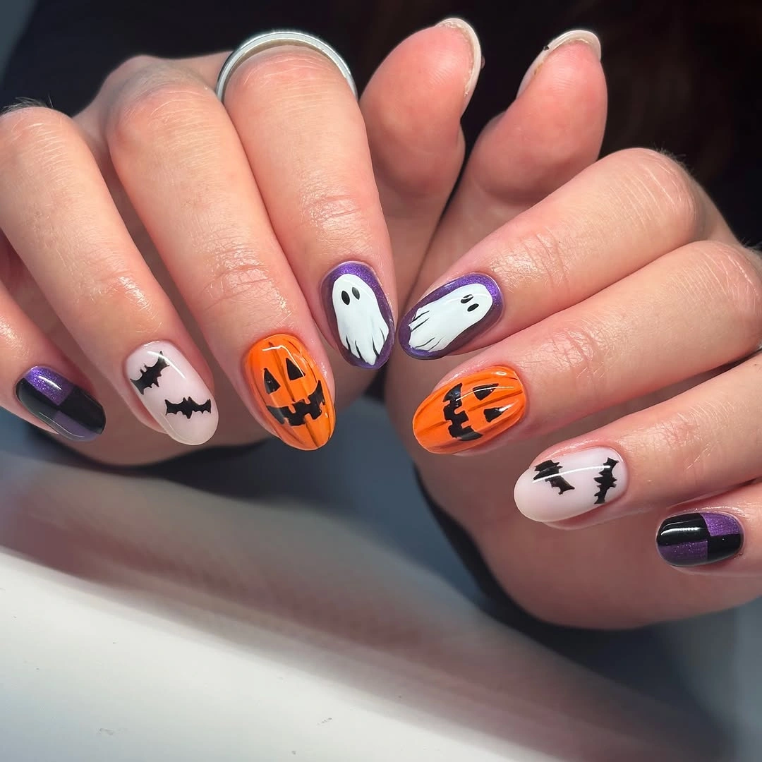 Medium almond purple orange nails with bats pumpkins and ghosts