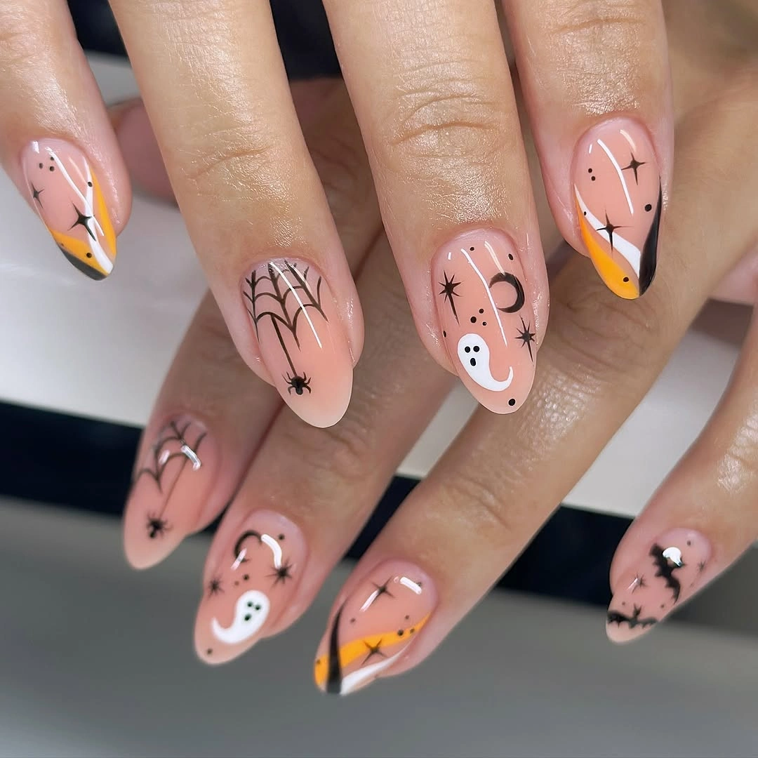 Medium almond pale pink nails with webs ghosts and orange tips