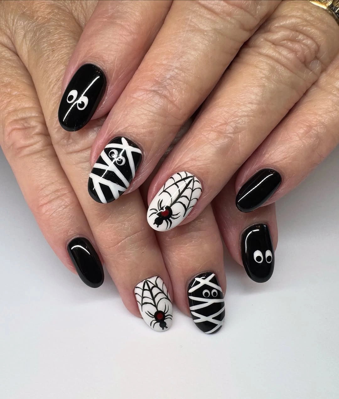 Medium almond black white nails with webs and crossed lines