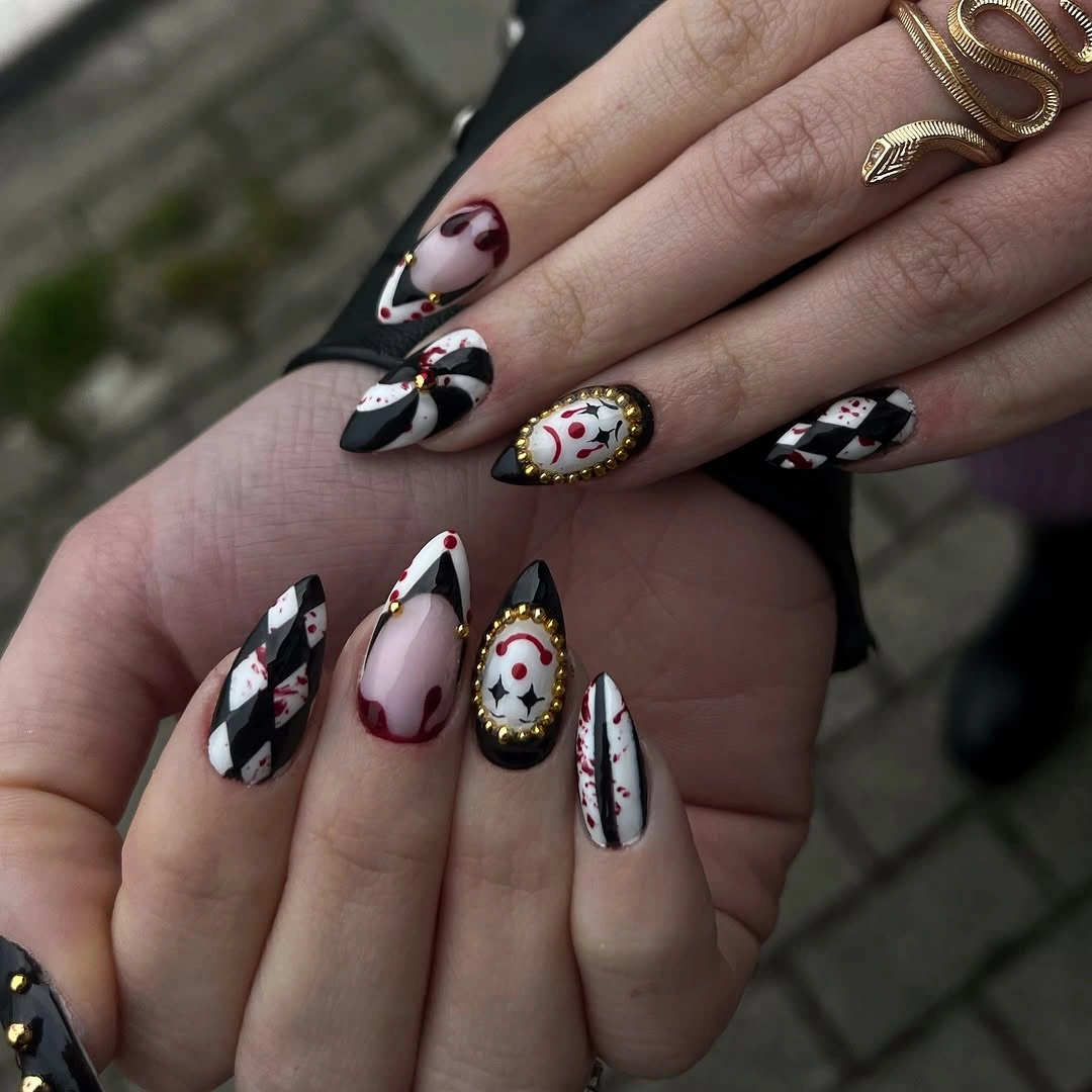 Long almond black white nails with gothic jewel graphic panels