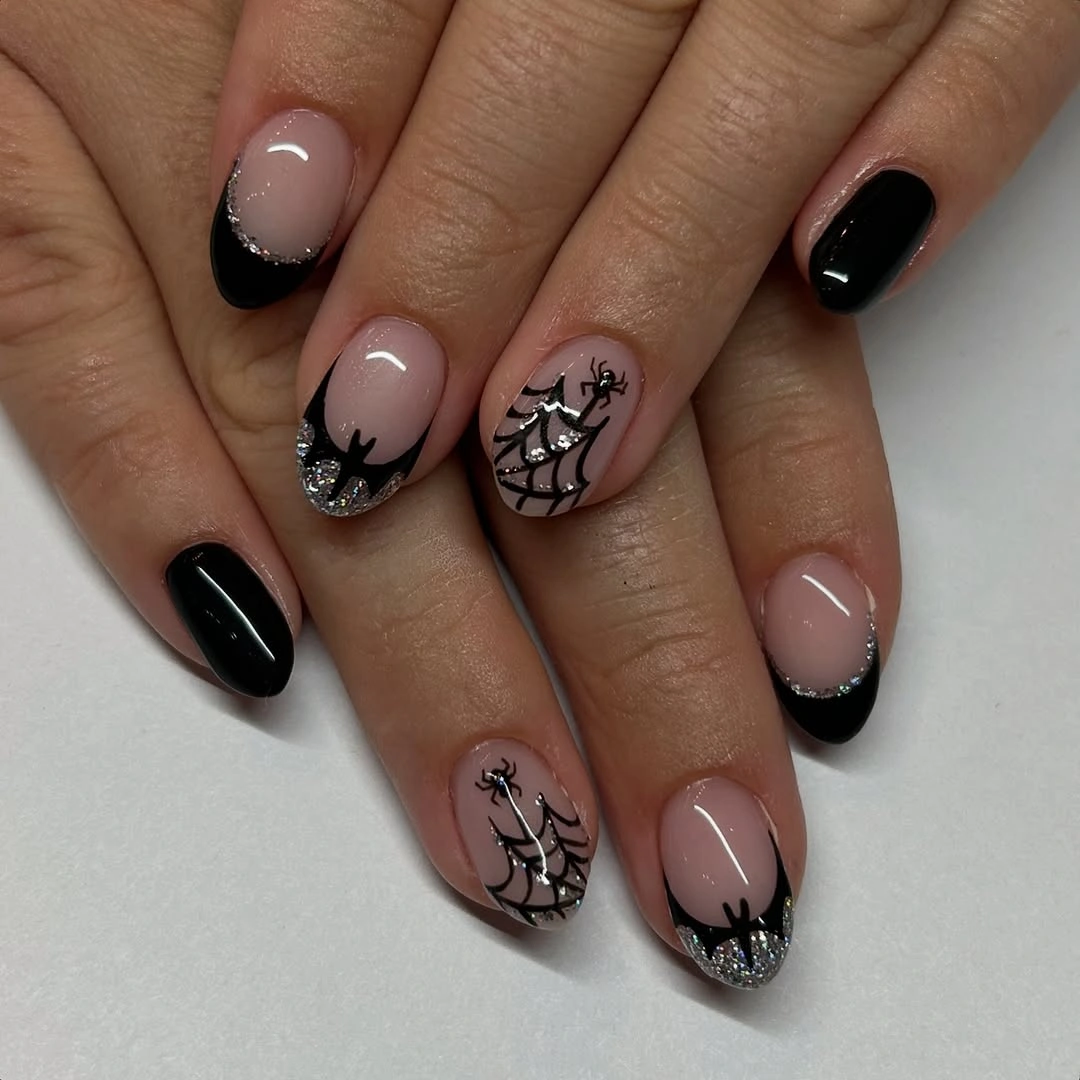 Medium almond pale pink nails with black webs and glossy accents