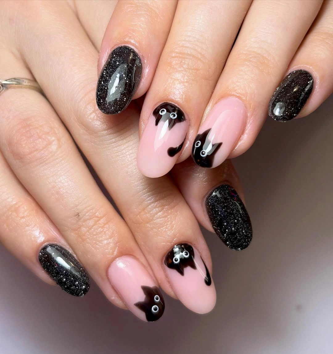 Medium almond black glitter nails with pale ghost bat accents