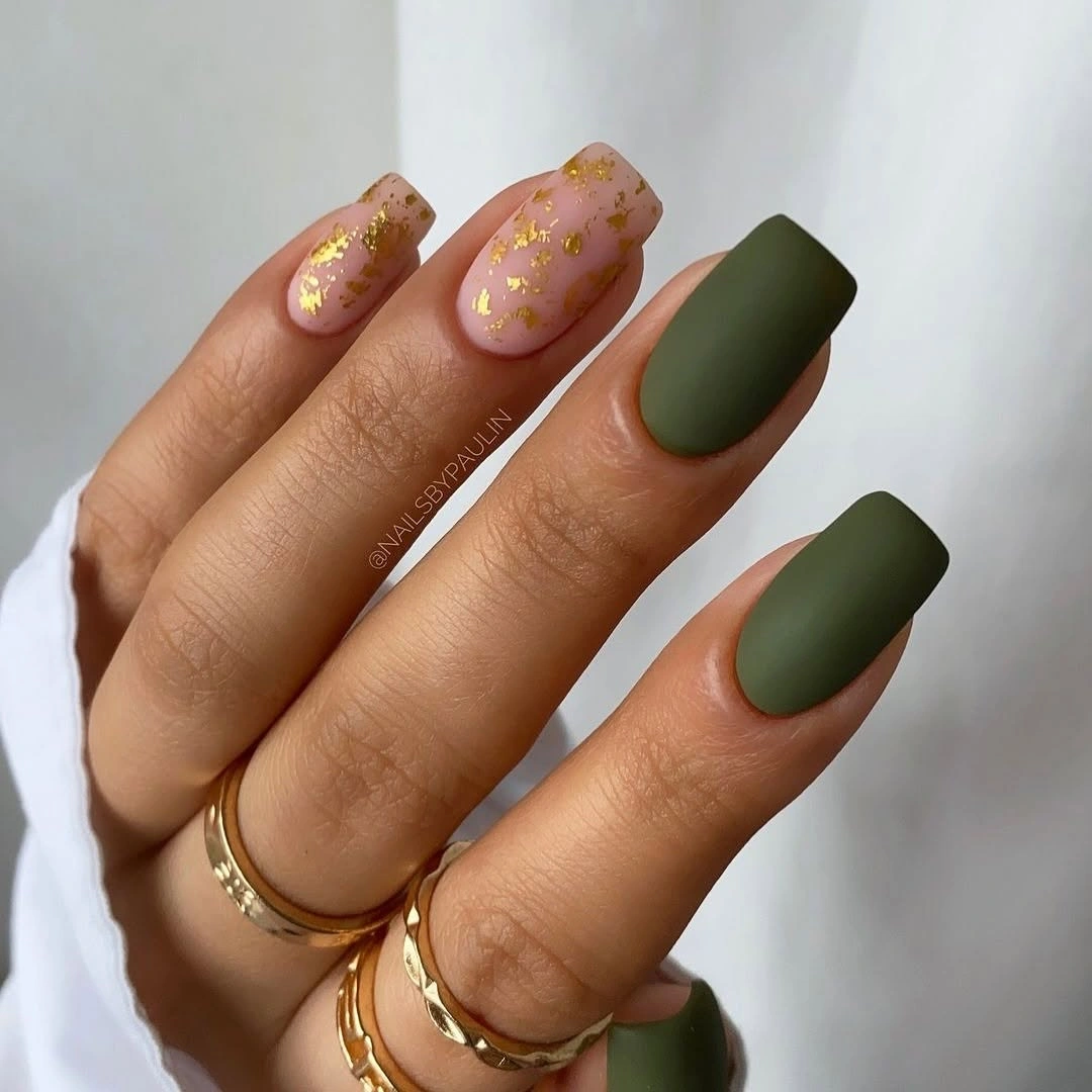 Matte olive almond nails with pale flecks and green edge