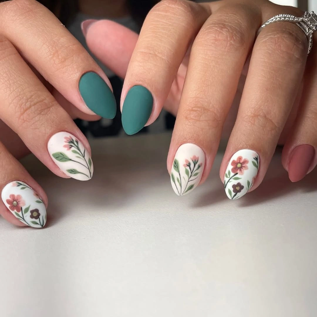 Matte teal nails with pale delicate floral accents