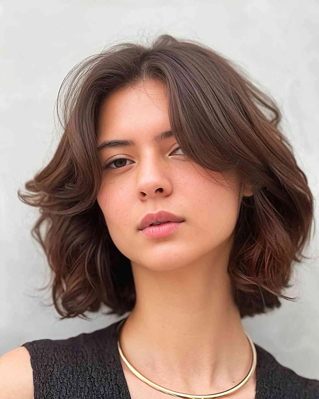 short dark bob with a center part and flipped ends