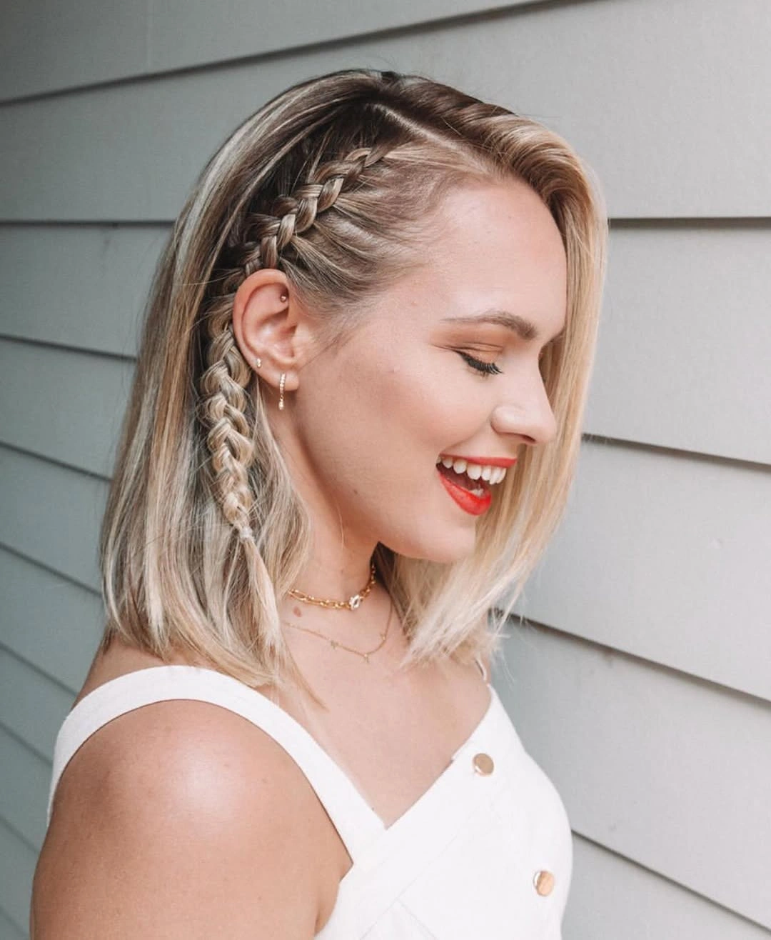 shoulder-length blonde waves with one side braid