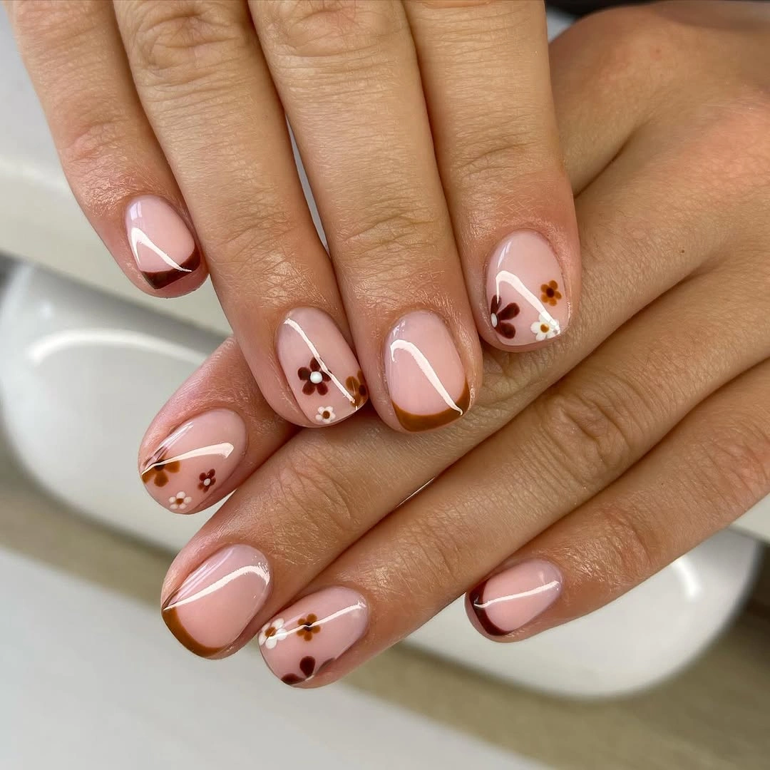 Short almond nude nails with white tips and brown fall marks