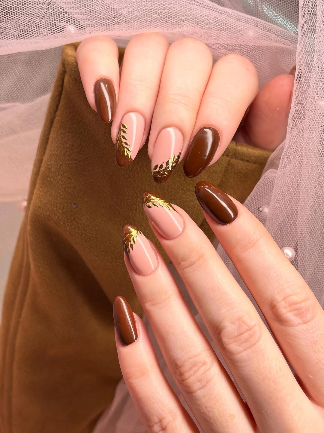 Long almond pale pink nails with chocolate tips and fine lines