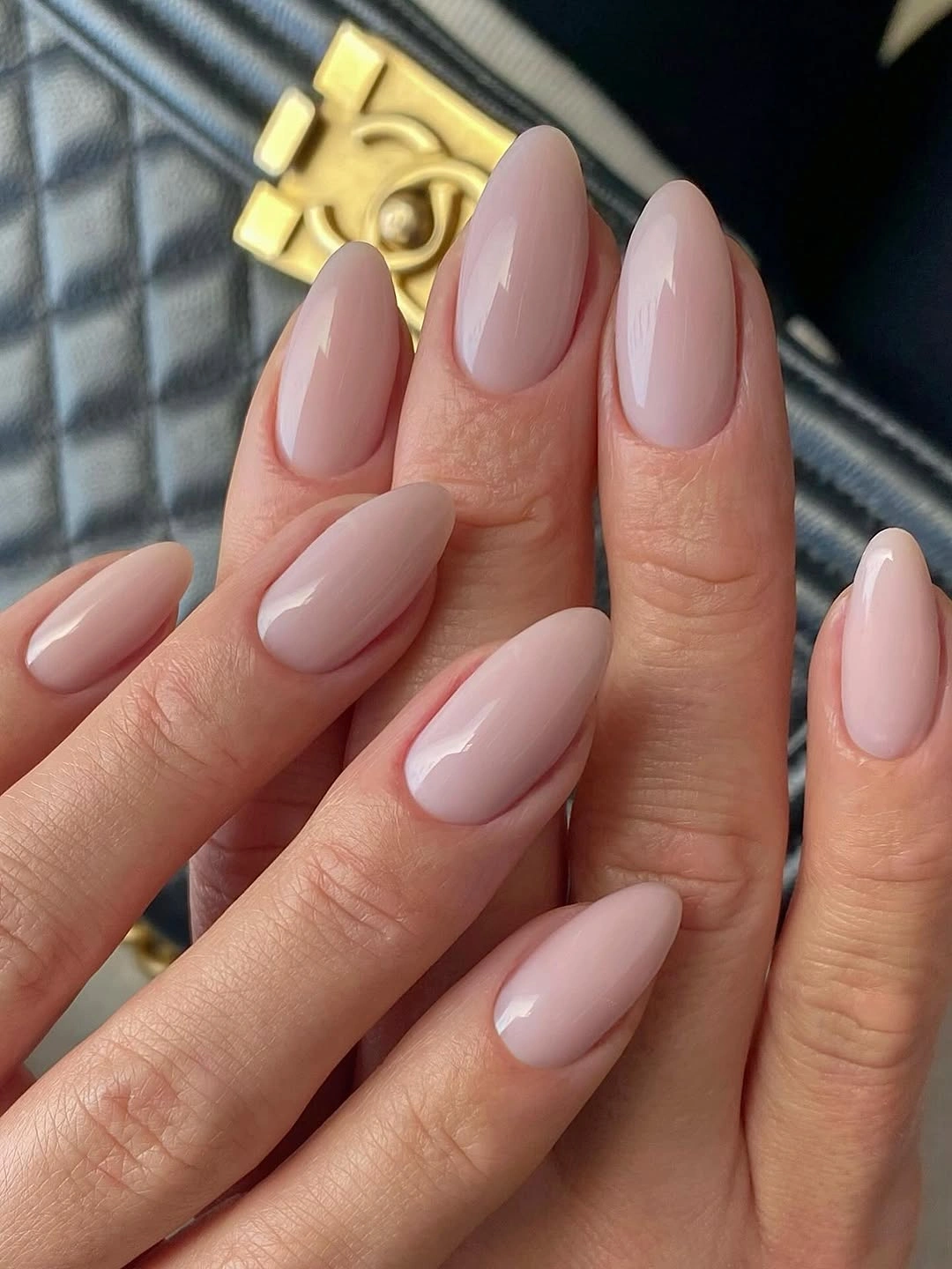 Long almond nails in uniform glossy pale pink nude