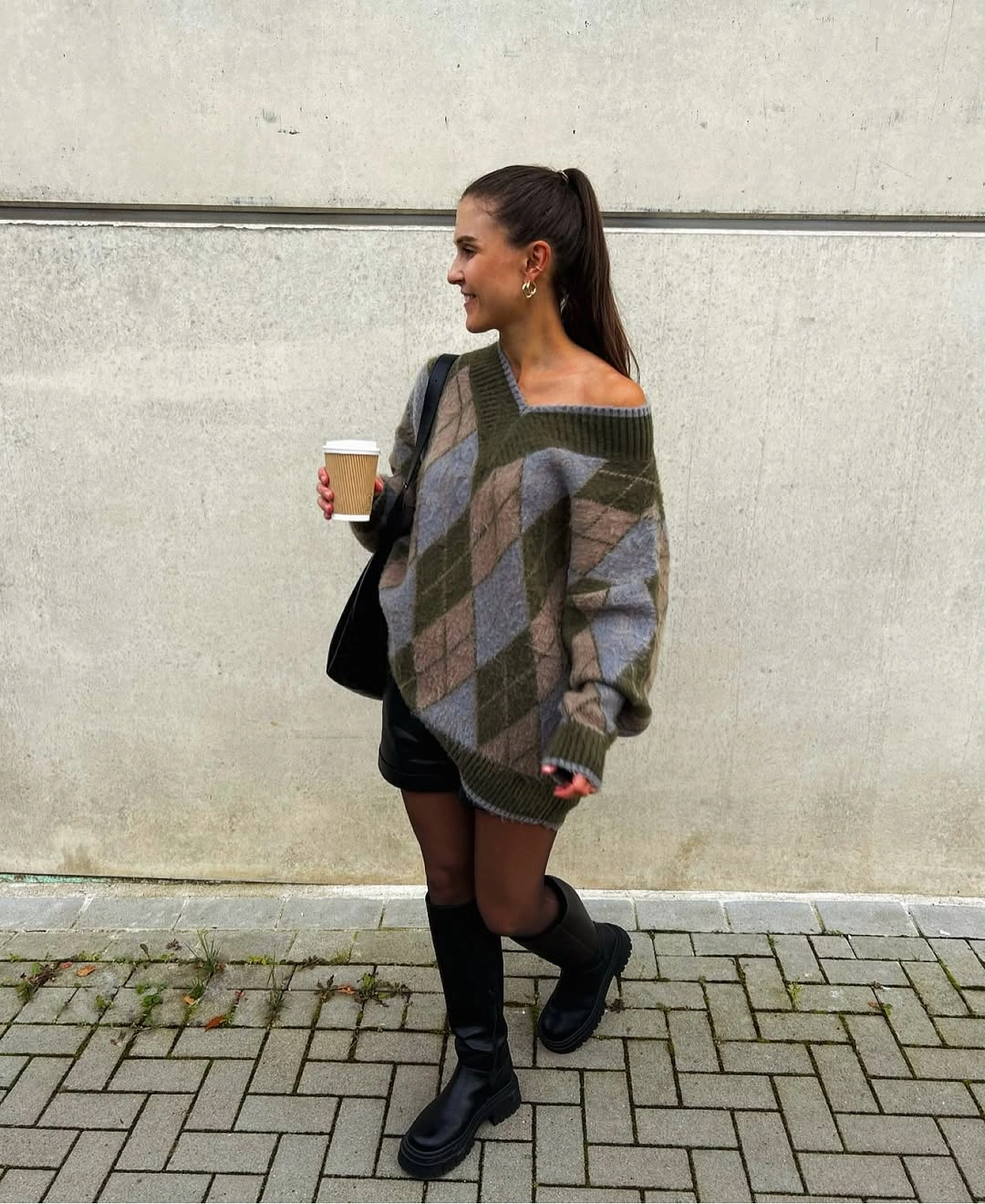 gray outfit with oversized knit over short dark base with tall boots