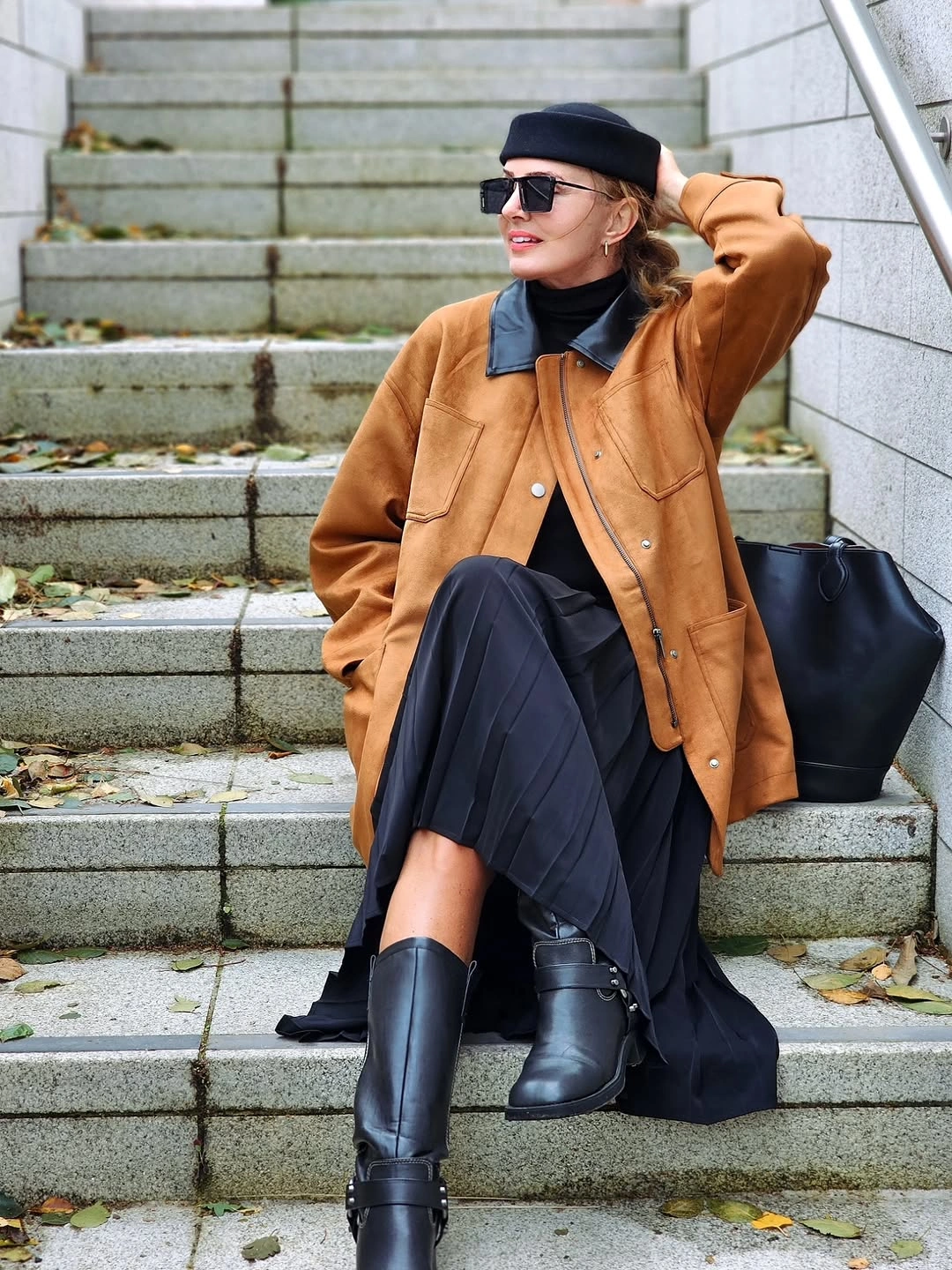 rust brown outfit with short structured jacket over long dark skirt with beret