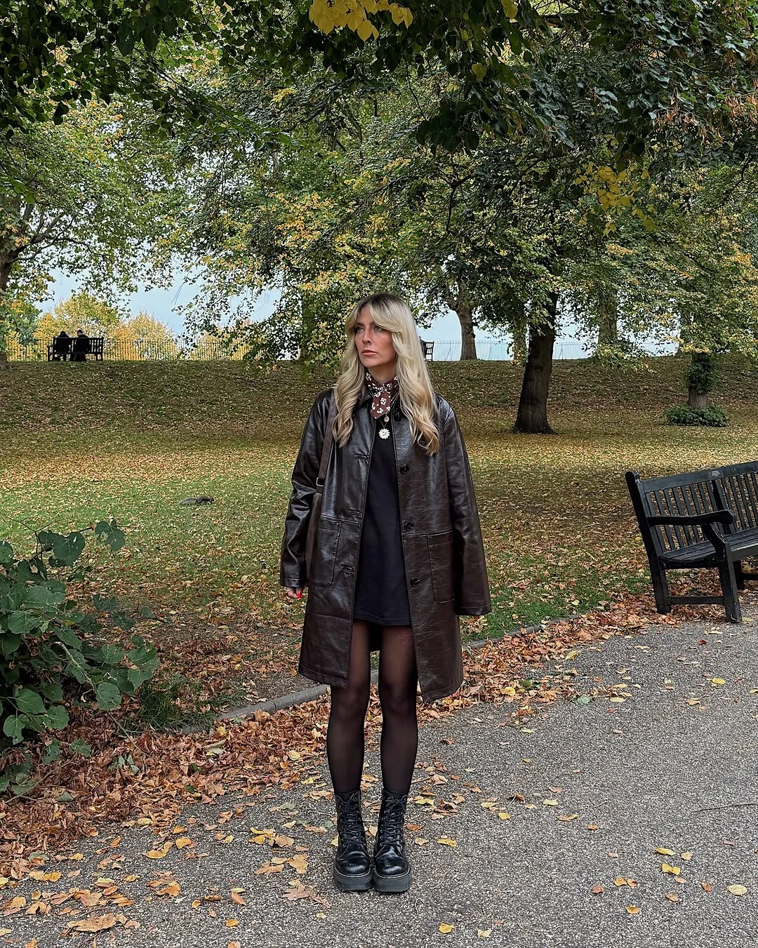 dark brown outfit with long coat over short dress with dark tights and shoes