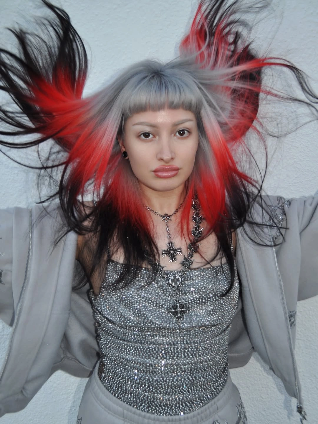 silver gray short choppy cut with short fringe with red panel accents
