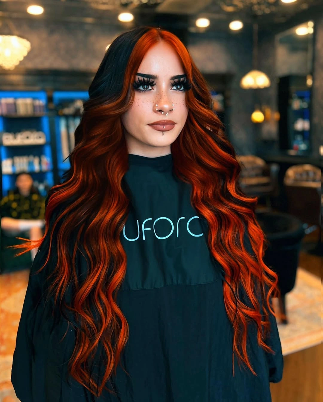 dark brown long layered waves with center part with copper face-framing ribbons