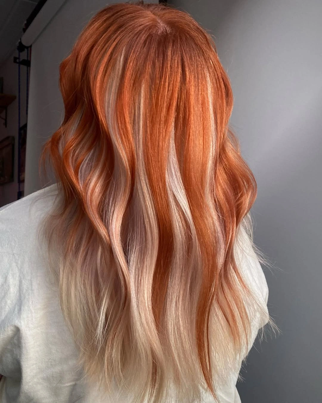 copper peach long layered waves with light ribbons through copper