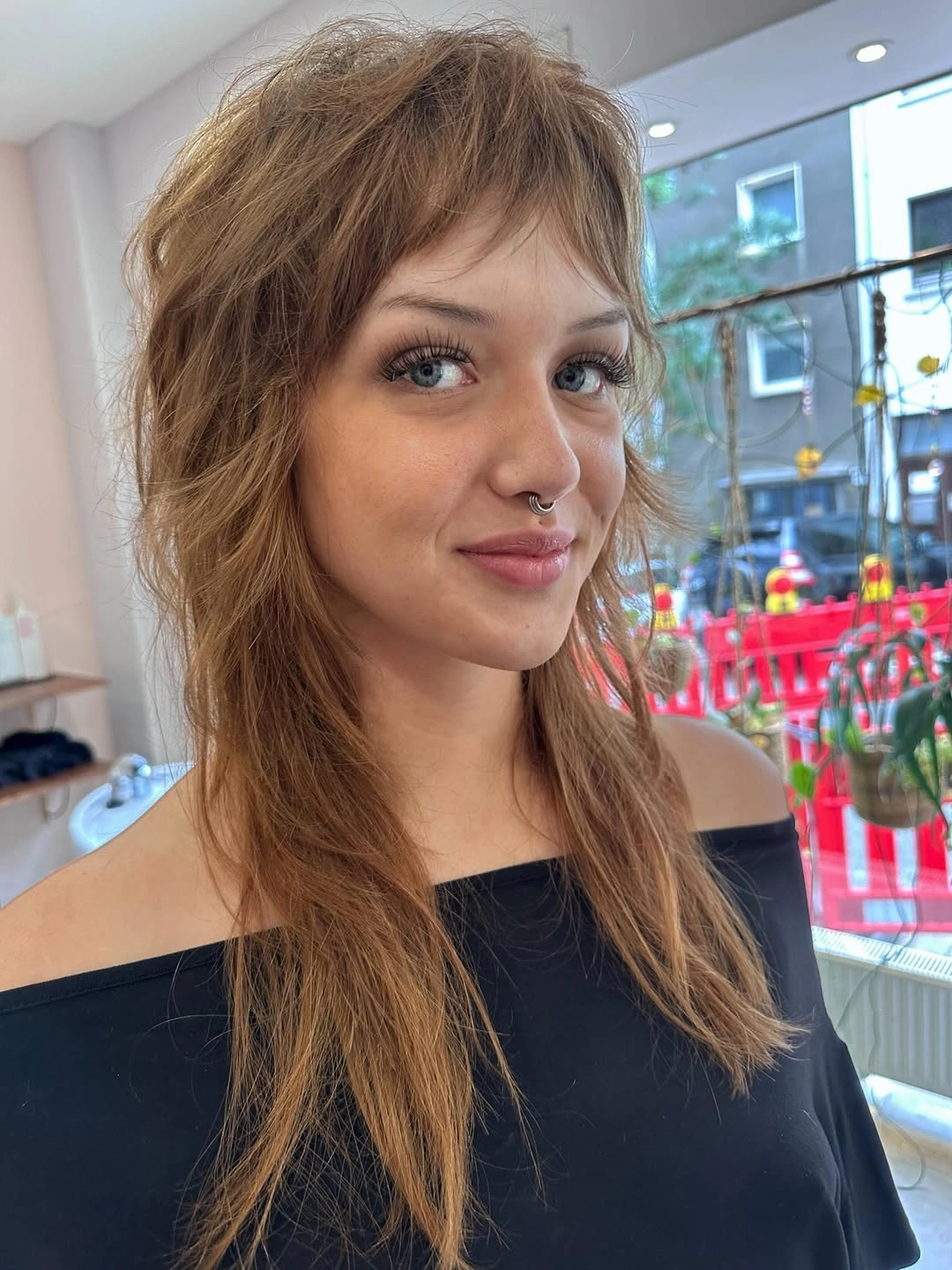 light brown shoulder-length soft shag with wispy fringe with wispy bangs