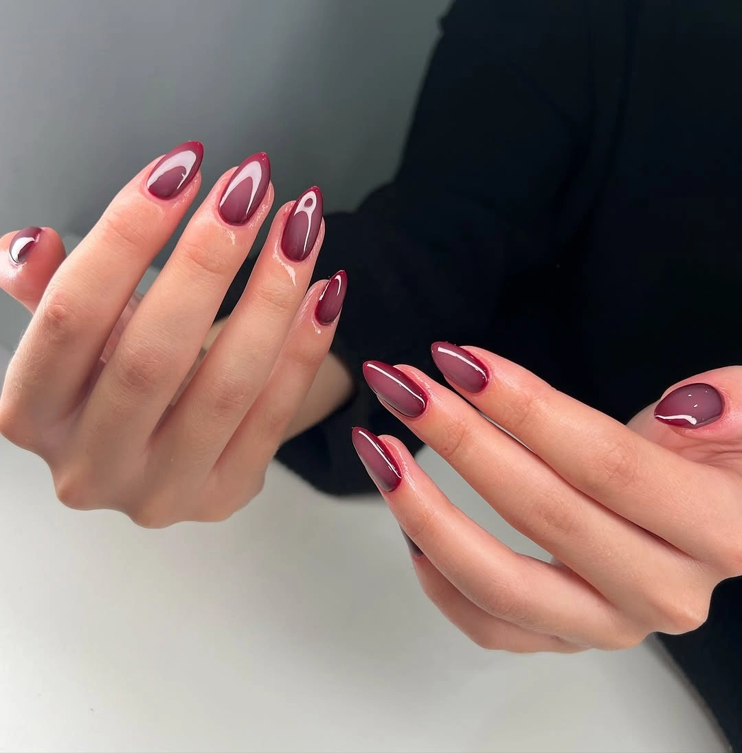 burgundy long almond nails with curved negative space
