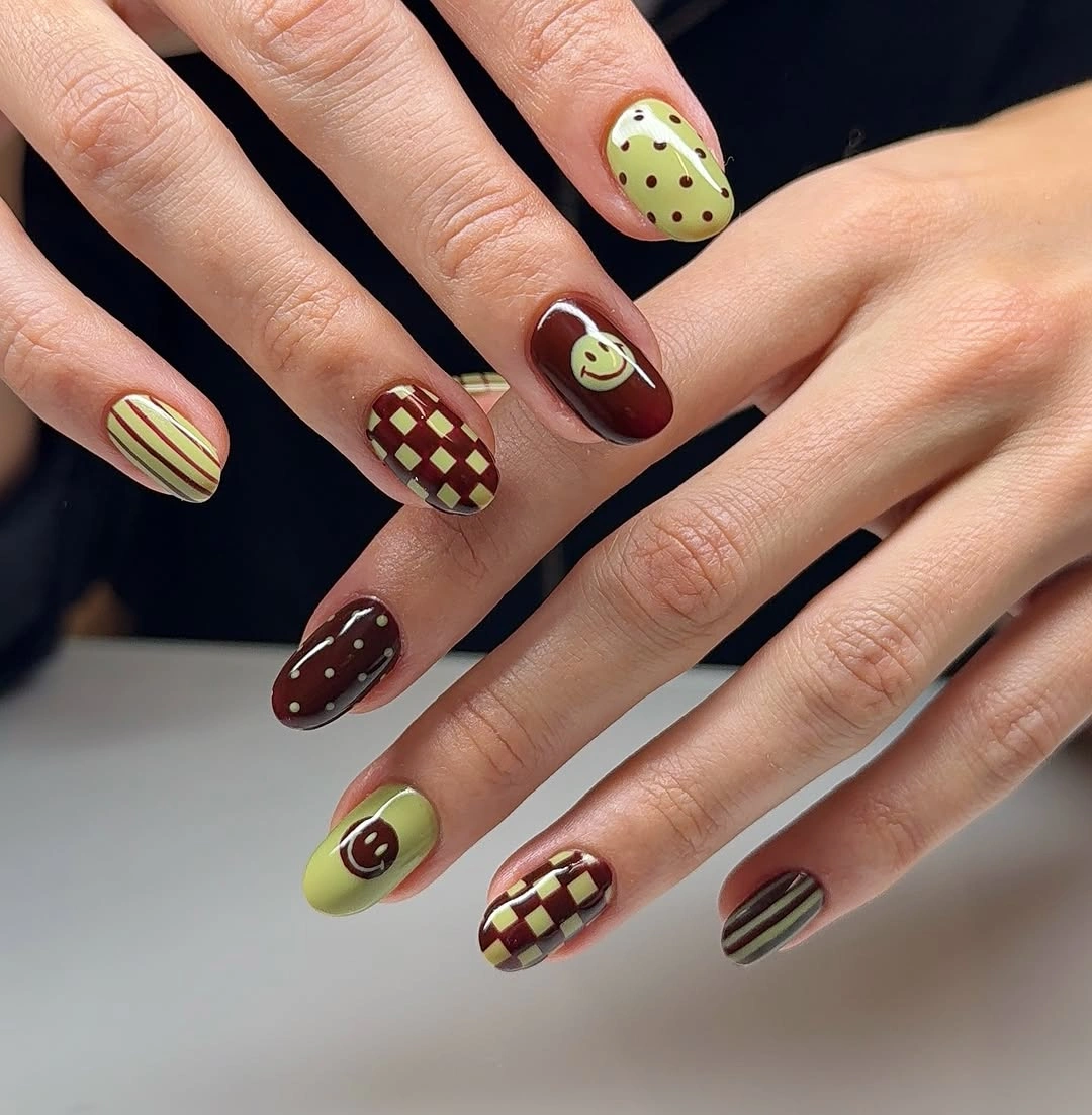 lime green short rounded nails with checkerboard and marks