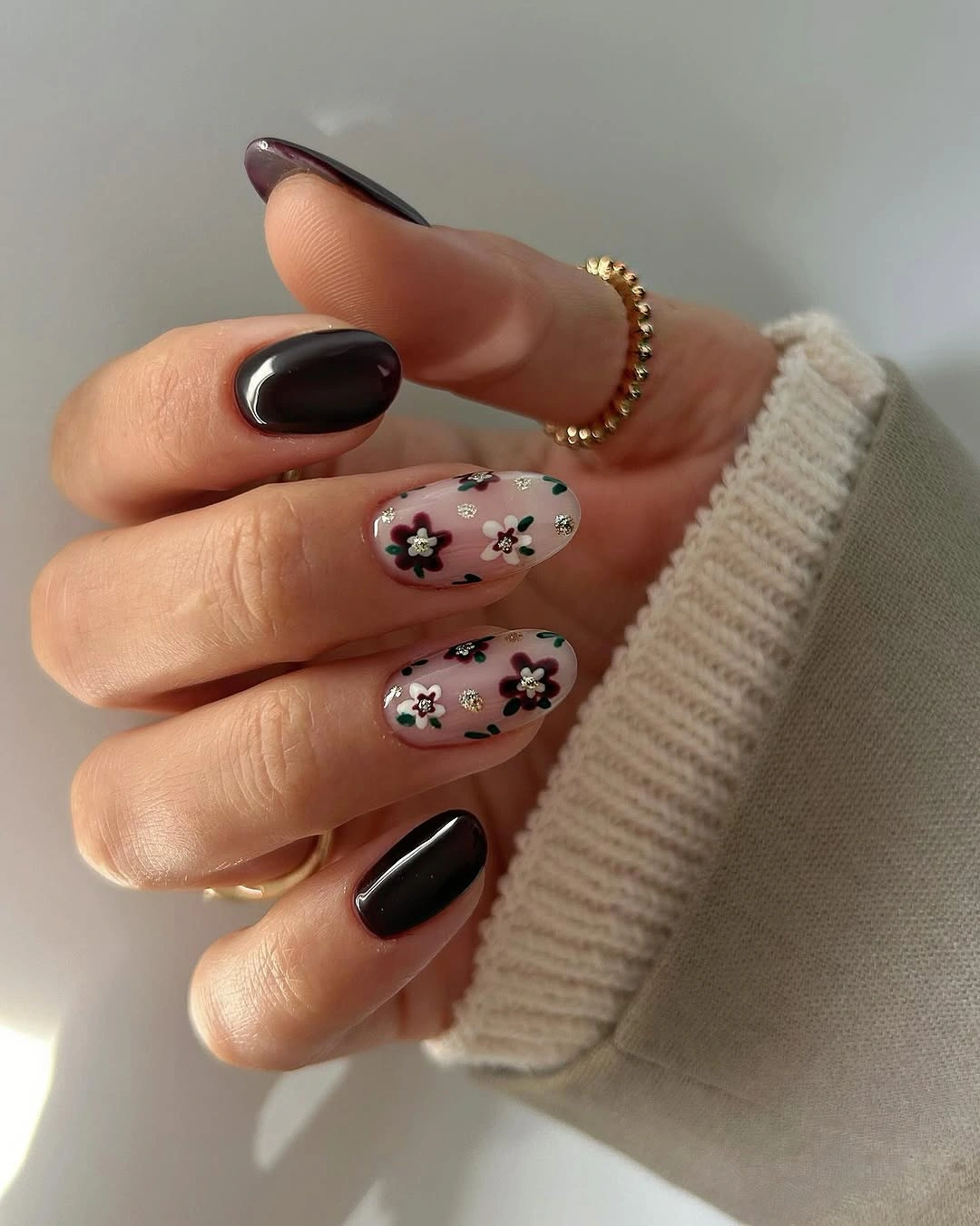 pale pink short rounded nails with green tips and small flowers