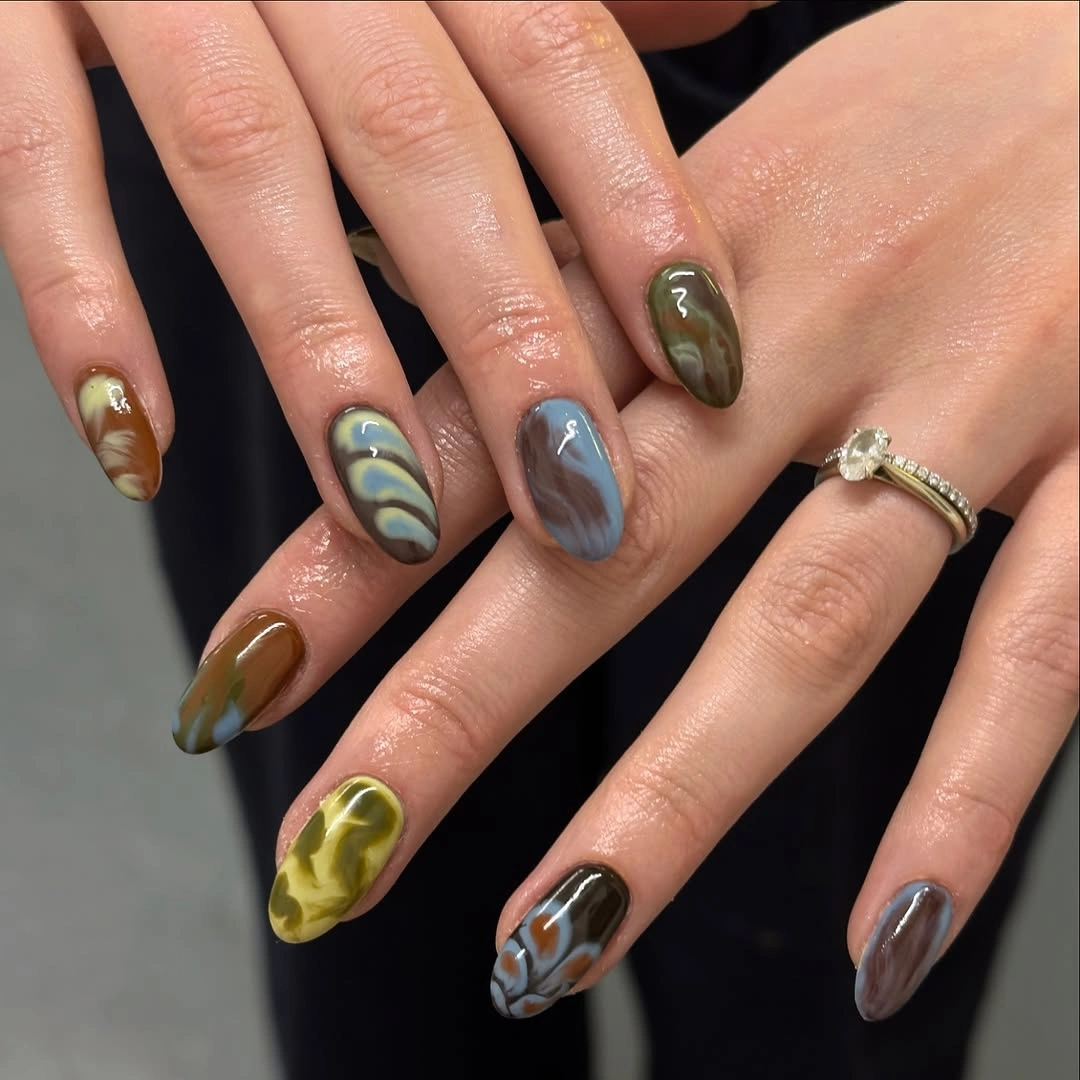 dark gray medium almond nails with botanical curves