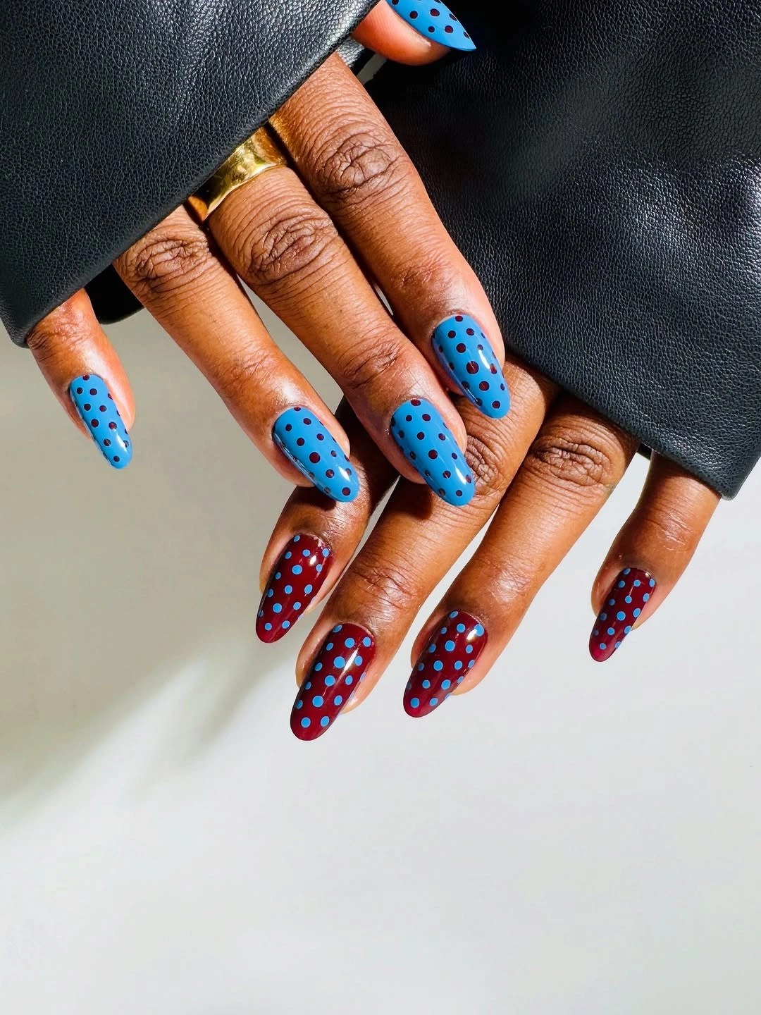 sky blue long pointed almond nails with contrasting dots