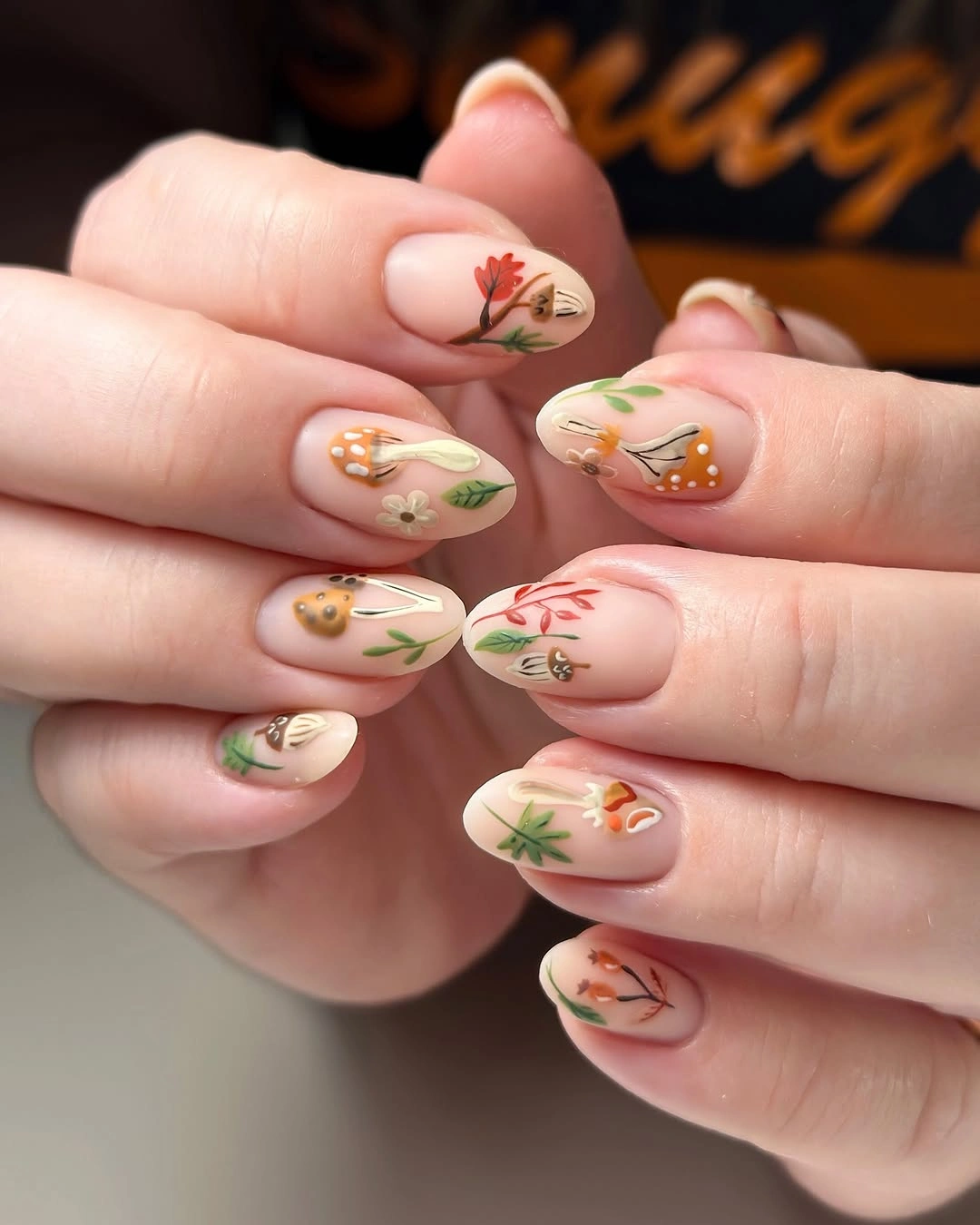 nude medium oval nails with autumn botanicals