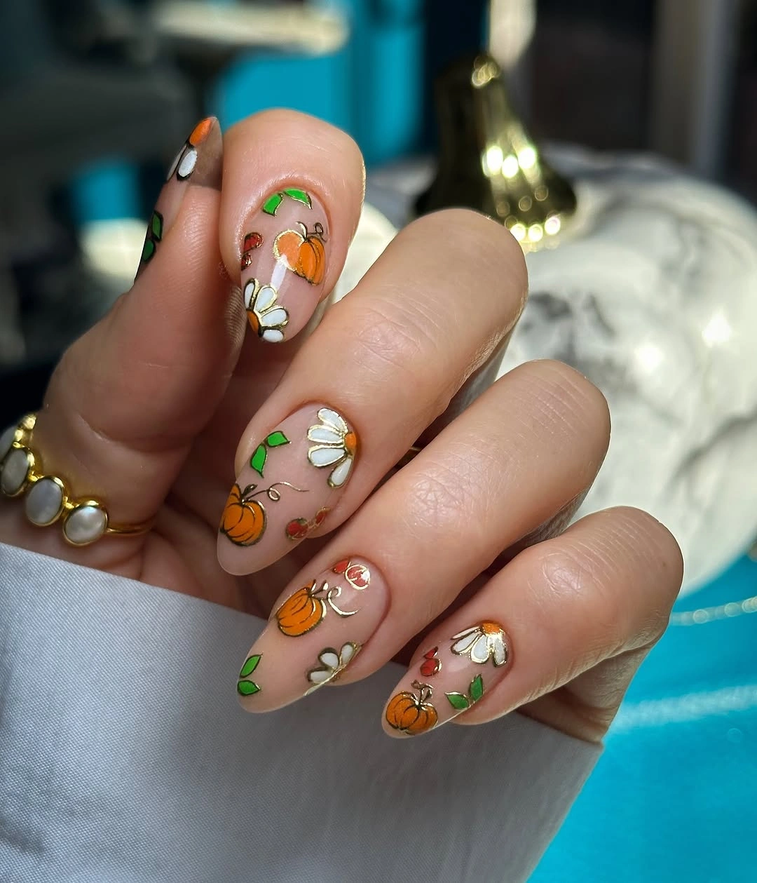 nude medium almond nails with pumpkins and flowers