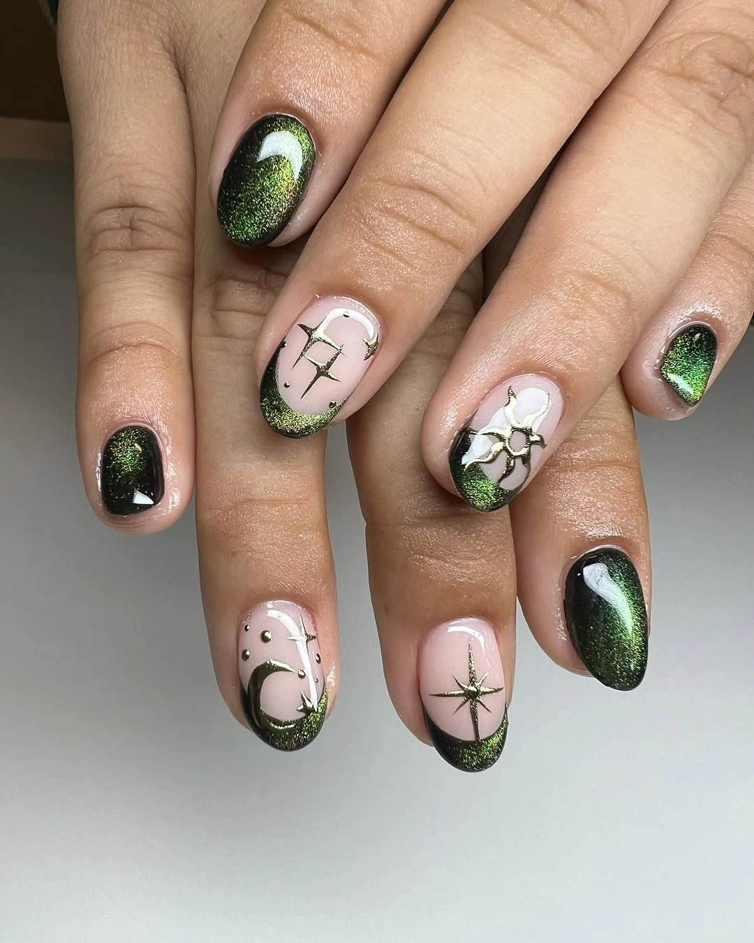 deep green short rounded nails with starbursts and branches
