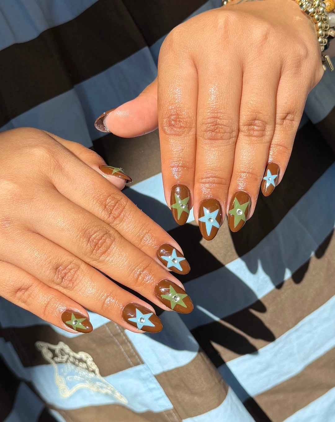 brown medium almond nails with stars