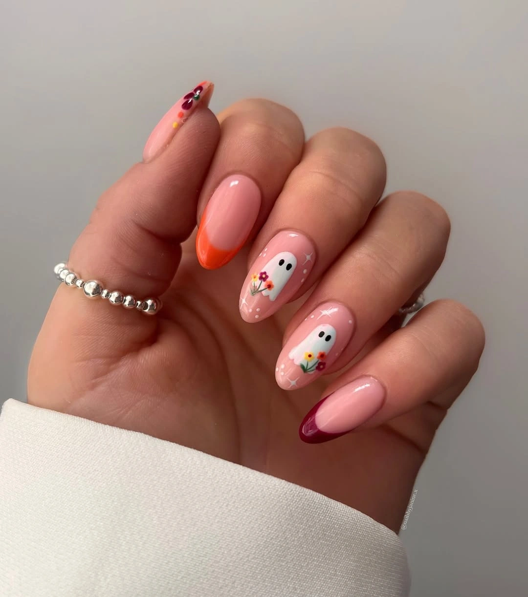 pale pink medium almond nails with colored tips and flowers