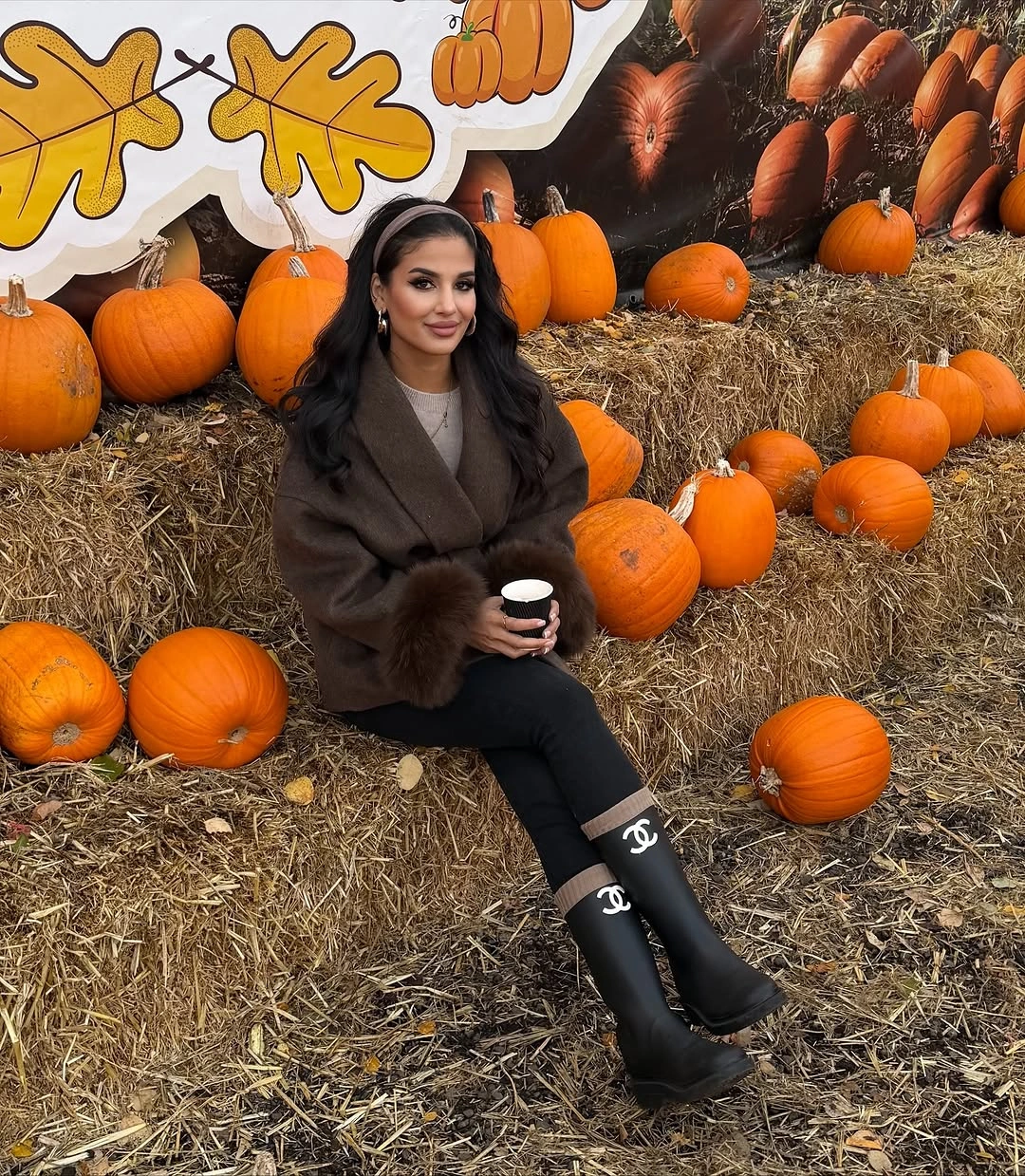 dark brown outfit with oversized warm upper layer over fitted leggings and tall boots