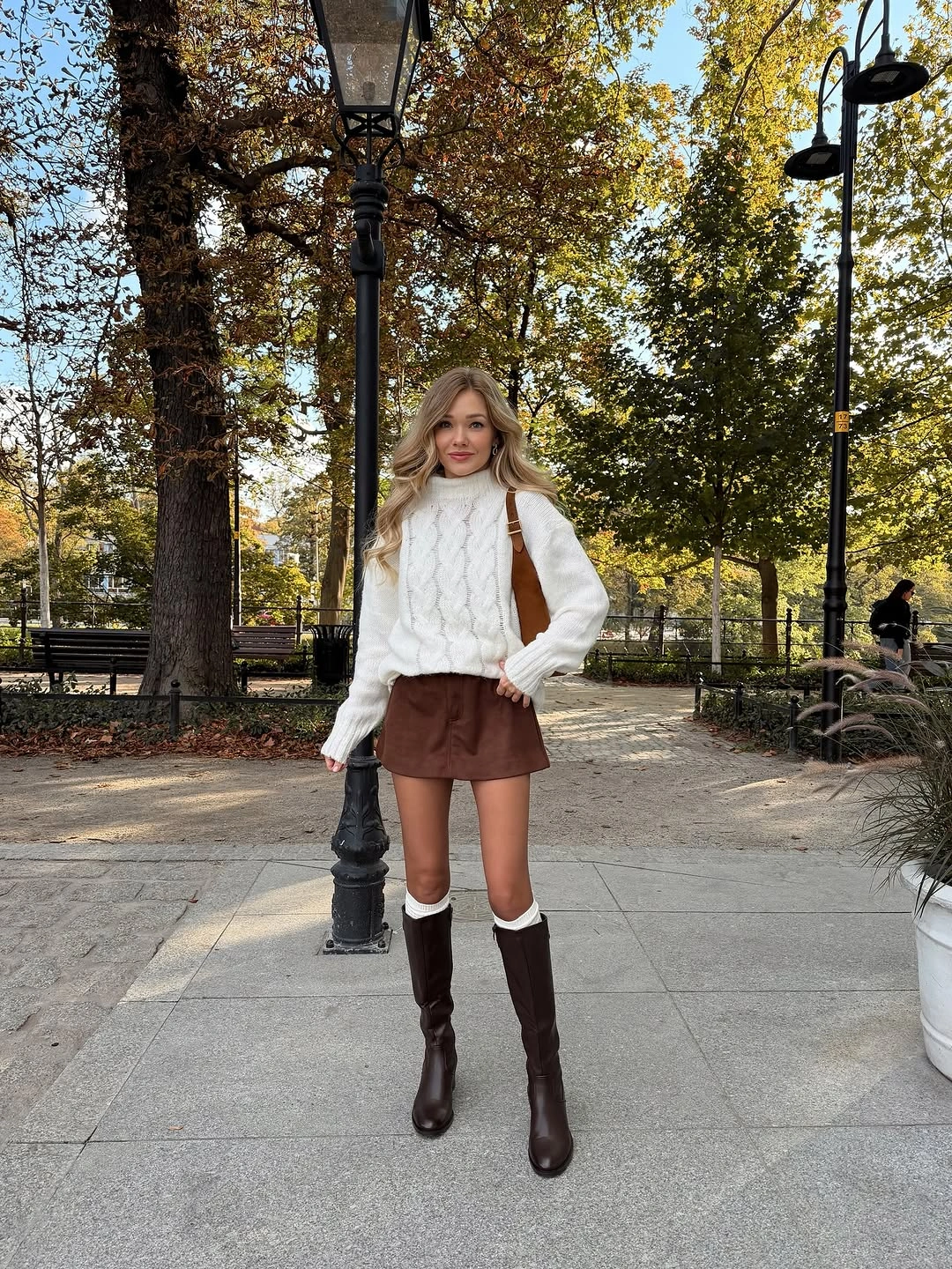 white outfit with chunky high-neck sweater over short skirt with tall boots