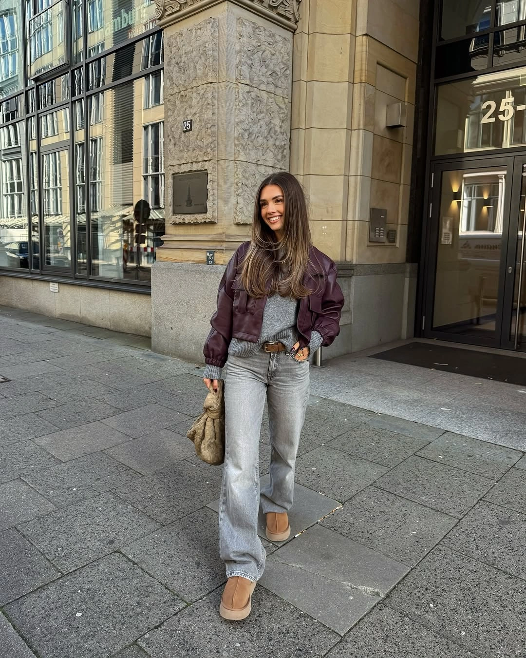 plum outfit with short jacket over wide-leg pale denim