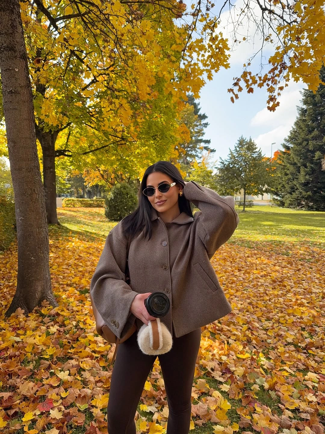 brown outfit with cropped jacket over fitted dark base