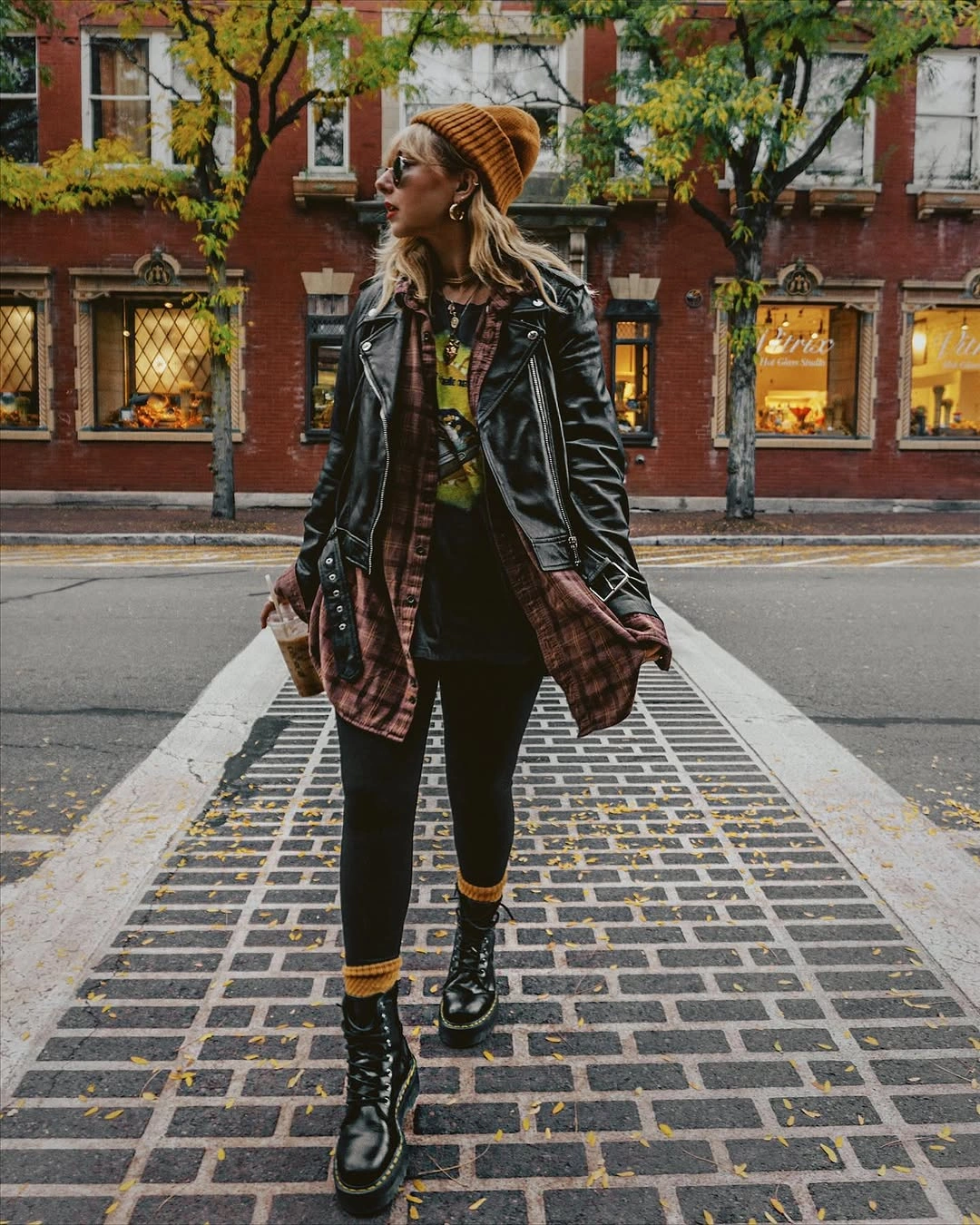 black outfit with dark jacket over long patterned dress with boots